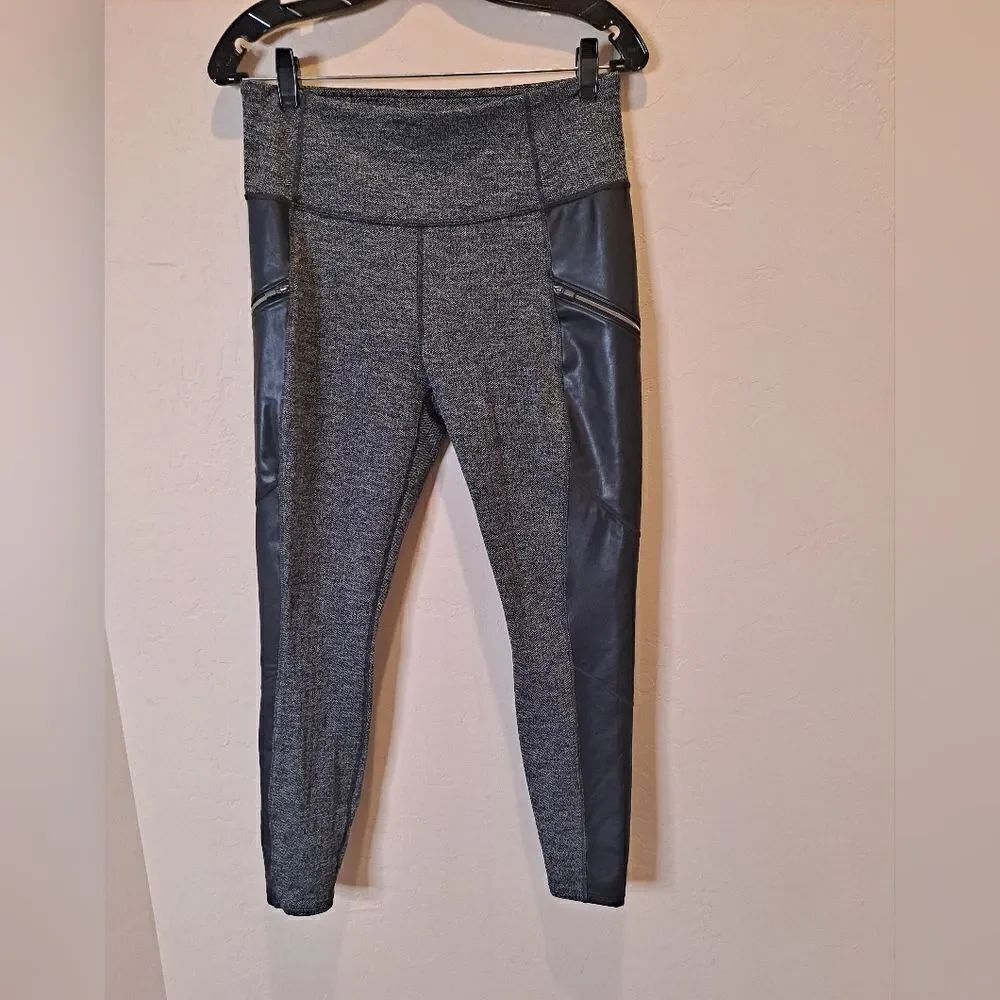 Athleta luxe drift metro moto legging with faux leather trim and zipper pockets.